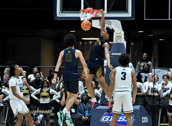 Wheeler Colben Landrew (3) dunks the ball against Pebblebrook during the second half in Class 6A Boys GHSA State Championship at the Macon Coliseum, Saturday, March 14, 2026, in Macon. Wheeler won 62-52 over Pebblebrook. (Hyosub Shin/AJC)