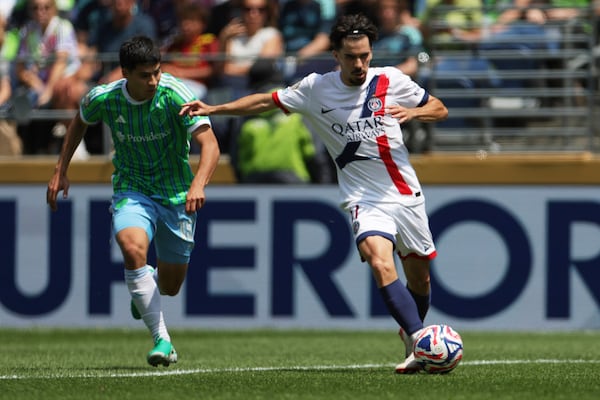 Paris Saint-Germain's Vitinha, right, passes the ball as Seattle Sounders' Obed Vargas looks on during the Club World Cup Group B soccer match between Seattle Sounders and PSG in Seattle, Monday, June 23, 2025. (AP Photo/Ryan Sun)
