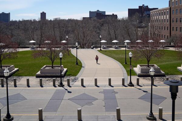 A person walks on campus at University of Minnesota in Minneapolis on April 21, 2020. (Glenn Stubbe/Star Tribune via AP, File)
