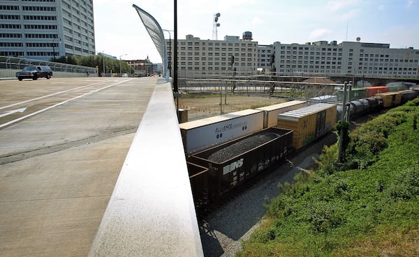 Norfolk Southern trains travels under the newly opened Mitchell Street Bridge in downtown Atlanta Thursday morning in Atlanta, Ga., August 23, 2012. The former Norfolk Southern office building downtown is visible to the right. AJC File Photo