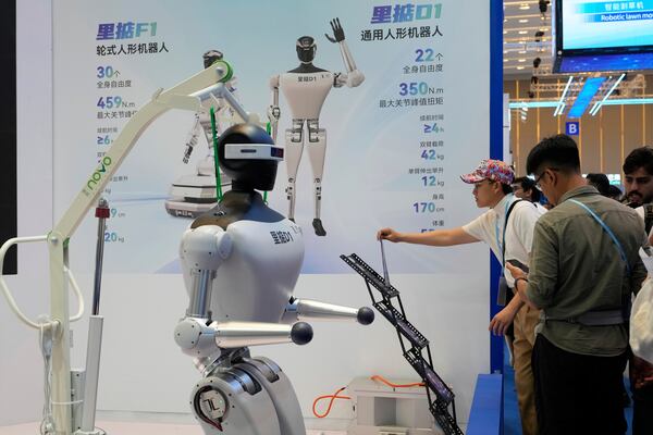 Visitors look at robots at the 137th Canton Fair in Guangzhou in southern China's Guangdong province on Wednesday, April 16, 2025. (AP Photo/Ng Han Guan)