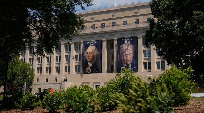 Banners of former President George Washington and President Donald Trump hang above an entrance to the Department of the Interior, Thursday, June 25, 2026, in Washington. (AP Photo/Carolyn Kaster)