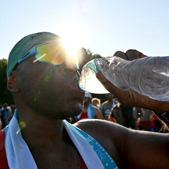 FILE: A runner cools down after crossing the finish line of the 56th running of the Atlanta Journal-Constitution Peachtree Road Race in Atlanta on Friday, July 4, 2025. (Hyosub Shin / AJC)