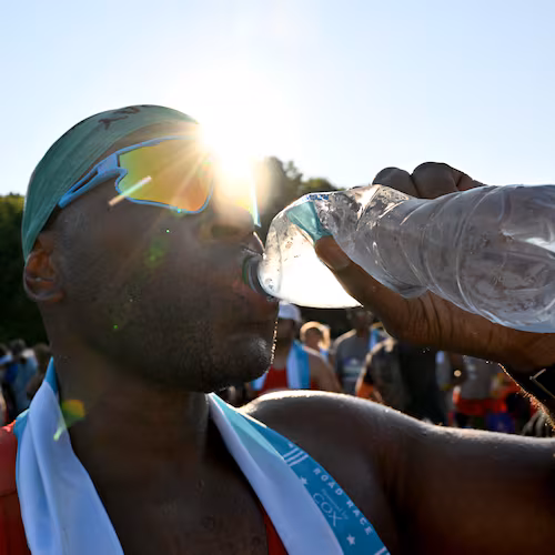 FILE: A runner cools down after crossing the finish line of the 56th running of the Atlanta Journal-Constitution Peachtree Road Race in Atlanta on Friday, July 4, 2025. (Hyosub Shin / AJC)