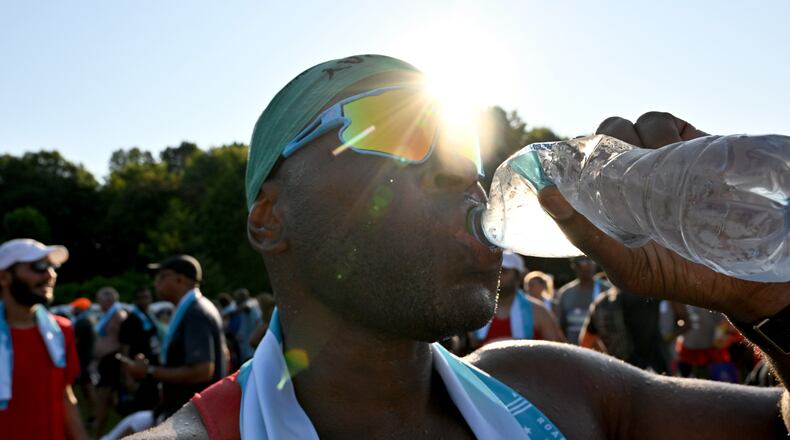 FILE: A runner cools down after crossing the finish line of the 56th running of the Atlanta Journal-Constitution Peachtree Road Race in Atlanta on Friday, July 4, 2025. (Hyosub Shin / AJC)