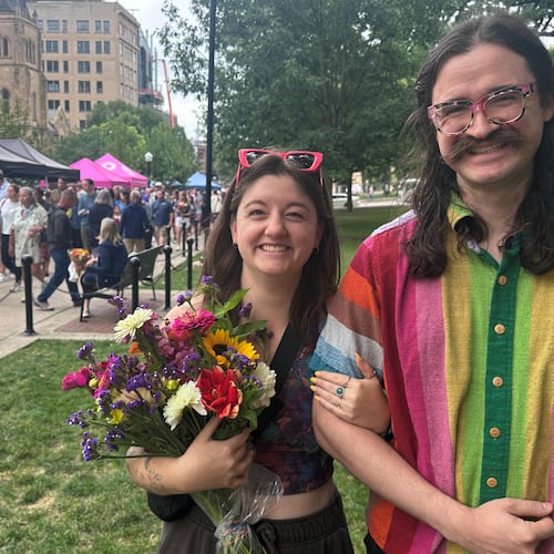 Alison Berube, left, and Charles Alt, right, are photographed at the farmers market on Saturday, July 25, 2026, in Madison, Wis. (AP Photo/Scott Bauer)