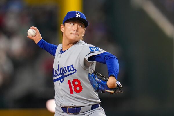 Los Angeles Dodgers starting pitcher Yoshinobu Yamamoto throws a pitch to the Texas Rangers during the first inning of a baseball game Friday, April 18, 2025, in Arlington, Texas. (AP Photo/Julio Cortez)