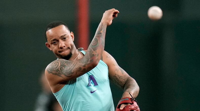 Returning Arizona Diamondbacks' Ketel Marte throws during infield practice prior to a baseball game against the Philadelphia Phillies, Monday, Aug. 31, 2026, in Phoenix. (AP Photo/Ross D. Franklin)
