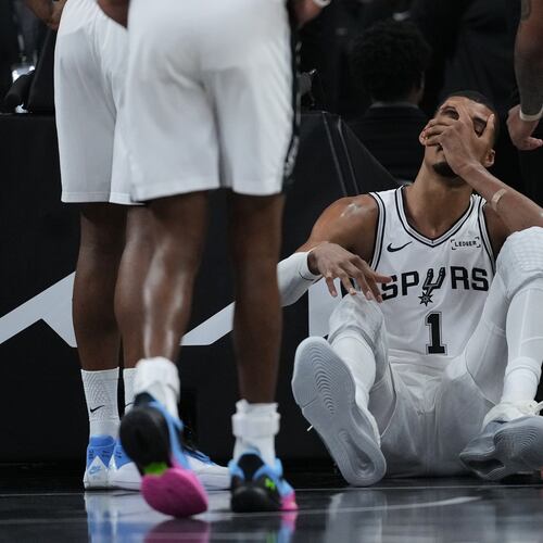 San Antonio Spurs forward Victor Wembanyama (1) sits on the court after a hard fall during the first half in Game 2 of a first-round NBA playoffs basketball series against the Portland Trail Blazers in San Antonio, Tuesday, April 21, 2026. (AP Photo/Eric Gay)
