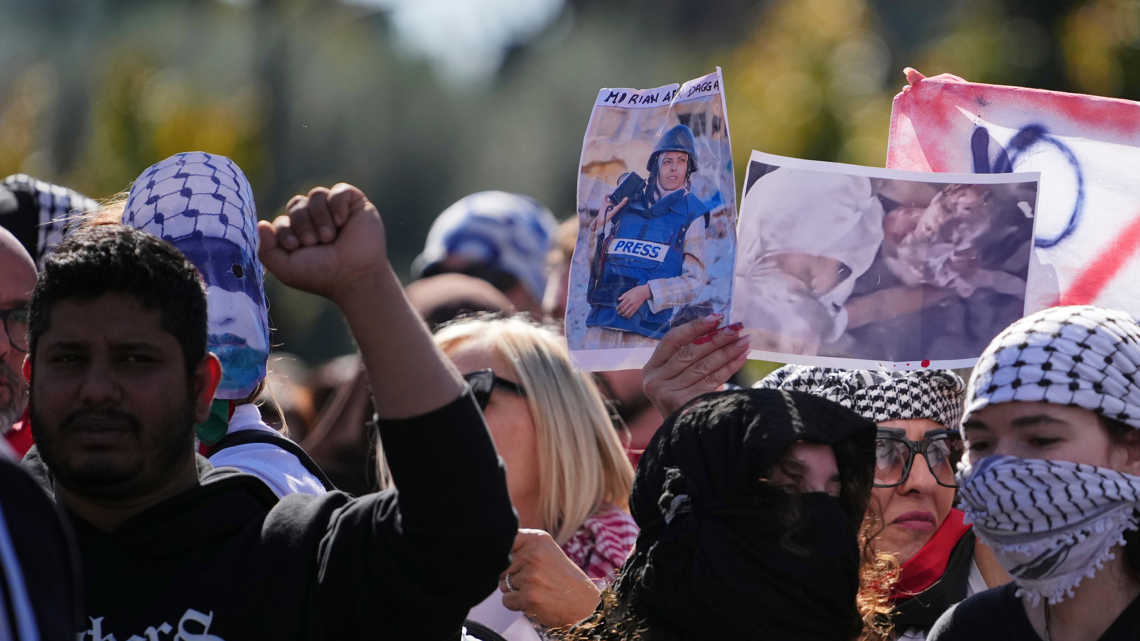 Pro Palestinian demonstrators hold up a photograph of Mariam Dagga, a visual journalist who freelanced for The Associated Press, killed in an Israeli strike in August, as they march during a national demonstration in support of the population of Gaza, in Rome, Saturday, Oct. 4, 2025. (AP Photo/Alessandra Tarantino)