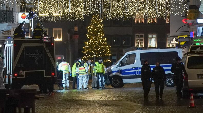 A police car stands in Simeonstrasse pedestrian shopping street following an apparent motorist attack that so far has left four people dead, including one child, and about 15 injured on Dec. 1, 2020 in Trier, Germany. According to witnesses, a man driving an SUV drove through Simeonstrasse at high speed, hitting people apparently at random. Police have arrested the man.