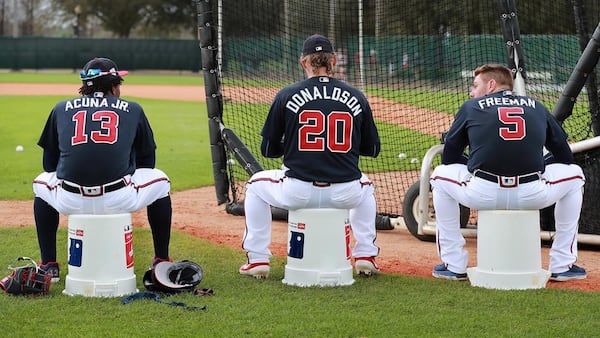 Braves players Ronald Acuna (from left), Josh Donaldson, and Freddie Freeman use empty baseball buckets to sit on while waiting their turn to bat during the first full squad workout at spring training in the ESPN Wide World of Sports Complex on Thursday, Feb. 21, 2019, in Lake Buena Vista. Curtis Compton/ccompton@ajc.com