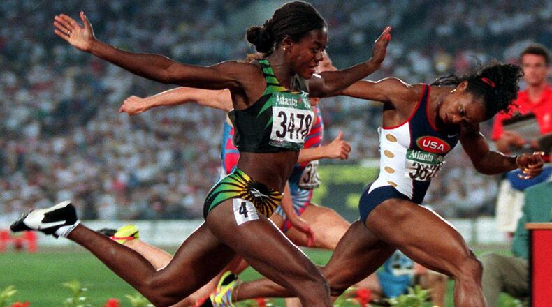 Gail Devers (right), of the U.S., and Merlene Ottey, of Jamaica, cross the finish line in the 1996 Summer Olympics women's 100-meter final Saturday, July 27, 1996, at Olympic Stadium in Atlanta. Devers won gold. (Michael Probst/AP)