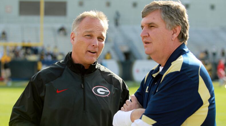 November 30, 2013 - Atlanta, Ga.: University of Georgia coach Mark Richt, left, talks with Georgia Tech coach Paul Johnson before their game at Bobby Dodd Stadium Saturday afternoon in Atlanta, Ga., November 30, 2013. JASON GETZ / JGETZ@AJC.COM Mark Richt and Paul Johnson discuss their strategy for "Sack Schultz" contest. (AJC)