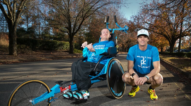 November 28, 2017 - Roswell, Ga: Brothers Brent, right, and Kyle Pease are shown with their race chair at the Kyle Pease Foundation Tuesday, November 28, 2017, in Roswell, Ga. Kyle, who was born with cerebral palsy spastic quadriplegia that affects all four limbs, is unable to walk. But with the help of his older brother Brent, Kyle is a two-time Ironman. The Pease brothers started the Kyle Pease Foundation. Their mission is to help other disabled individuals experience the joy of sport by providing medical and adaptive sports equipment, mobility devises and medical care. This will be published in the March issue of Living Northside. PHOTO / JASON GETZ