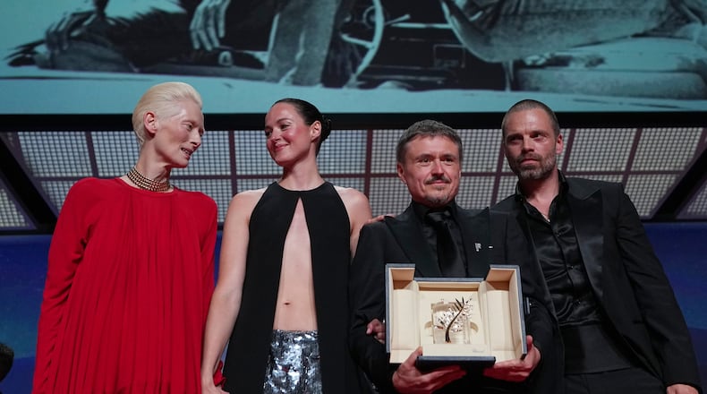 Tilda Swinton, left, poses with Renate Reinsve, Cristian Mungiu, winner of the Palme d'Or for 'Fjord' and Sebastian Stan during the awards ceremony at the 79th international film festival, Cannes, southern France, Saturday, May 23, 2026. (AP Photo/Andreea Alexandru)