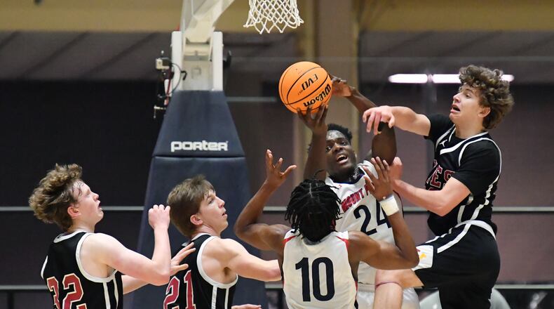 March 10, 2021 Macon - Mt. Pisgah's Nate Gordon (24) manages to grab a rebound as he falls during the 2021 GHSA State Basketball Class A Private Championship game at the Macon Centreplex in Macon on Wednesday, March 10, 2021. Mt. Pisgah won 43-41 over Holy Innocents. (Hyosub Shin / Hyosub.Shin@ajc.com)