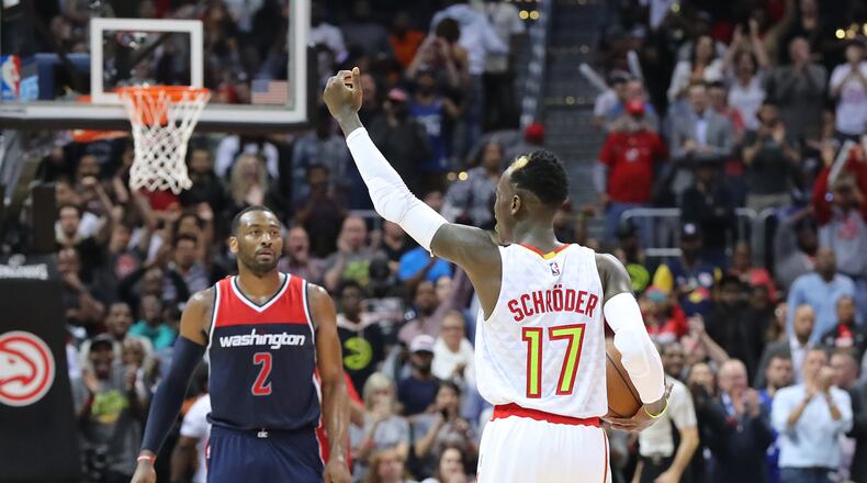 Atlanta Hawks Dennis Schroder encourages the crowd to cheer in the final minute of a 111-101 victory over the Washington Wizards with John Wall looking on in game 4 of a first-round NBA basketball playoff series on Monday, April 24, 2017, in Atlanta.