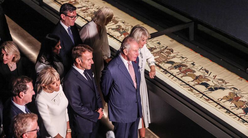 Britain's King Charles III and Queen Camilla, accompanied by The President of France Emmanuel Macron and Brigitte Macron, the Prime Minister, Andy Burnham and his wife Marie-France Van-Heel, view the Bayeux Tapestry Exhibition at the British Museum in London Wednesday, Sept. 2, 2026. (Richard Pohle, Pool Photo via AP)