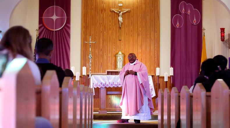 FILE - The Rev. Athanasius Abanulo, from Nigeria, celebrates Mass at Holy Family Catholic Church in Lanett, Ala., on Sunday, Dec. 12, 2021. He is one of numerous international clergy helping ease a U.S. priest shortage by serving in Catholic dioceses across the country. (AP Photo/Jessie Wardarski, File)