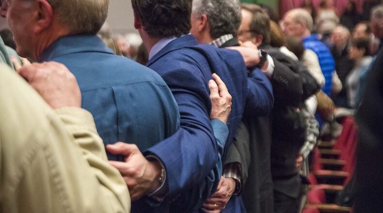 Members of the audience embrace as they sing a Jewish song at the end of the Jewish solidarity event at Byers Theatre in Sandy Springs, Monday, January 6, 2020. This event was held to bring the community together in response to the recent hate attacks in New York and New Jersey. The ADL, American Jewish Committee, Atlanta Rabbinical Association, Jewish Community Relations Council and the Jewish Federation of Greater Atlanta helped to bring the event together. (ALYSSA POINTER/ALYSSA.POINTER@AJC.COM)