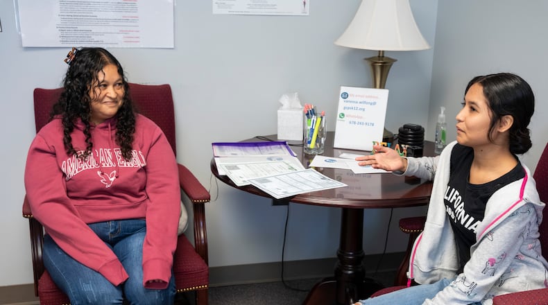 Martha Alicia Jimenez Zarco (left) and her daughter Blanca Estela Torres Jimenez (right) meet with advisers at the International Newcomer Center to fill out paperwork to enroll in the Gwinnett County school system on Monday, Oct. 9, 2023. (Olivia Bowdoin for The Atlanta Journal-Constitution)