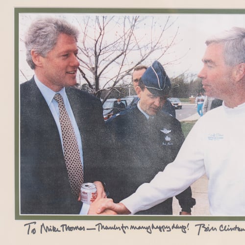 An inscribed photo of President Bill Clinton with Michael Thomas, the former manager of the Courses at Andrews at Joint Base Andrews, is seen Friday, Dec. 19, 2025, in Lothian, Md. (Michael Thomas via AP)