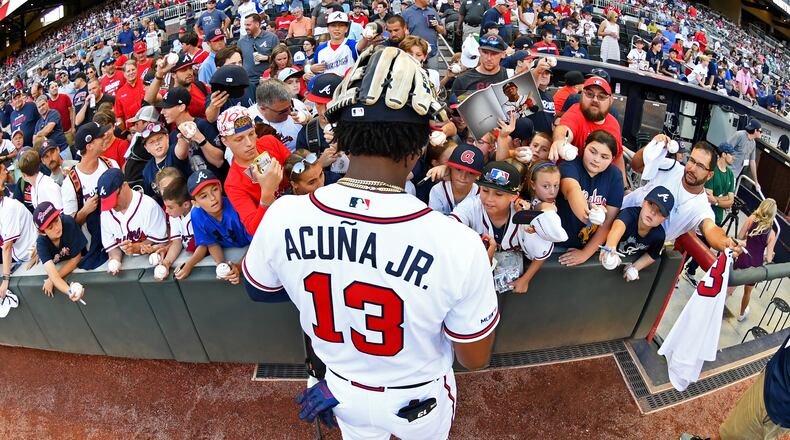The Braves’ Ronald Acuna signs autographs before the game against Kansas City Royals at SunTrust Park on Wednesday.