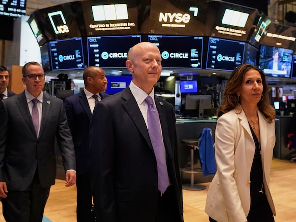 Jeremy Allaire, center, Co-Founder, Chairman & CEO of Circle, escorted by NYSE President Lynn Martin, right, on the floor of the New York Stock Exchange, Thursday, June 5, 2025. (AP Photo/Richard Drew)
