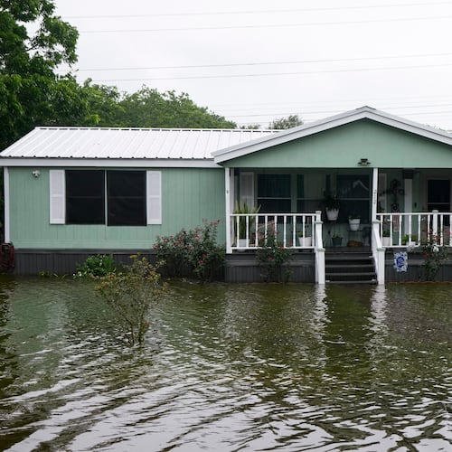 Water surrounds homes in the aftermath of Tropical Storm Arthur in rural Brazoria County, Texas, Wednesday, June 17, 2026. (Brett Coomer/Houston Chronicle via AP)