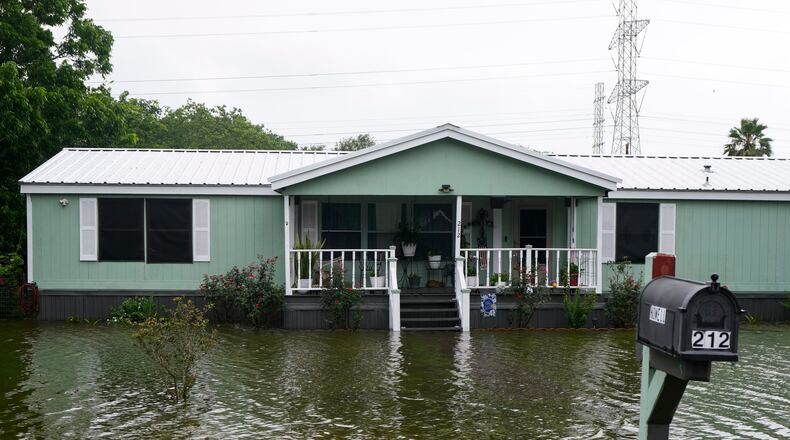 Water surrounds homes in the aftermath of Tropical Storm Arthur in rural Brazoria County, Texas, Wednesday, June 17, 2026. (Brett Coomer/Houston Chronicle via AP)