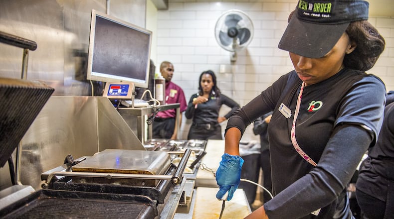 Shanterika Shealey uses a tethered knife to cut a sandwich at Fresh to Order at Hartsfield-Jackson International Airport. JONATHAN PHILLIPS / SPECIAL