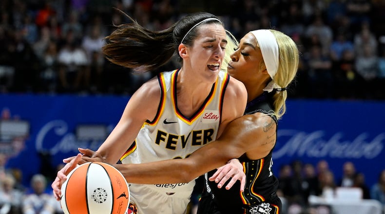 Connecticut Sun guard DiJonai Carrington (21) fouls Indiana Fever guard Caitlin Clark (22) during the third quarter of a WNBA basketball game, Tuesday, May 14, 2024, in Uncasville, Conn. (AP Photo/Jessica Hill)