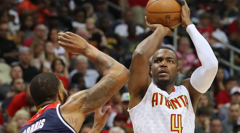 No crying, just scoring: Paul Millsap shoots over Washington Wizards Markieff Morris Saturday. (Curtis Compton/ccompton@ajc.com)