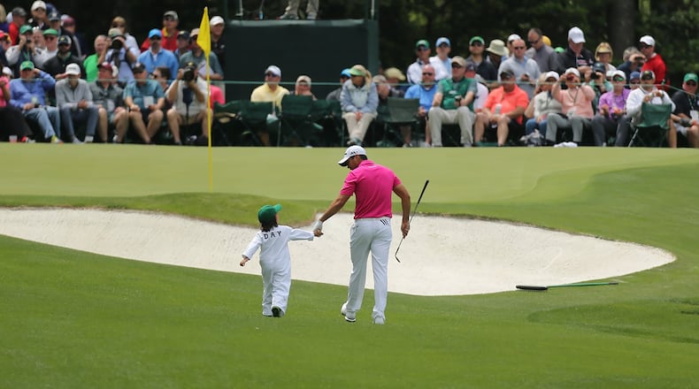 Jason Day walks to the 5th green holding hands with his son Dash during the Par 3 Contest at Augusta National Golf Club on Wednesday, April 6, 2016, in Augusta. (Curtis Compton/ccompton@ajc.com)