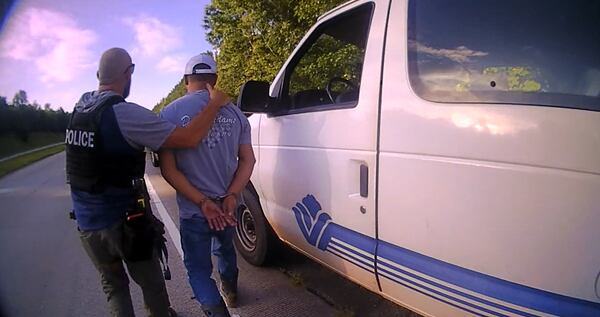 An ICE agent arrests a driver of work van stopped by Jefferson police officer Jordan Redman (left) on July 18, 2025. (Courtesy of Jefferson Police Department)
