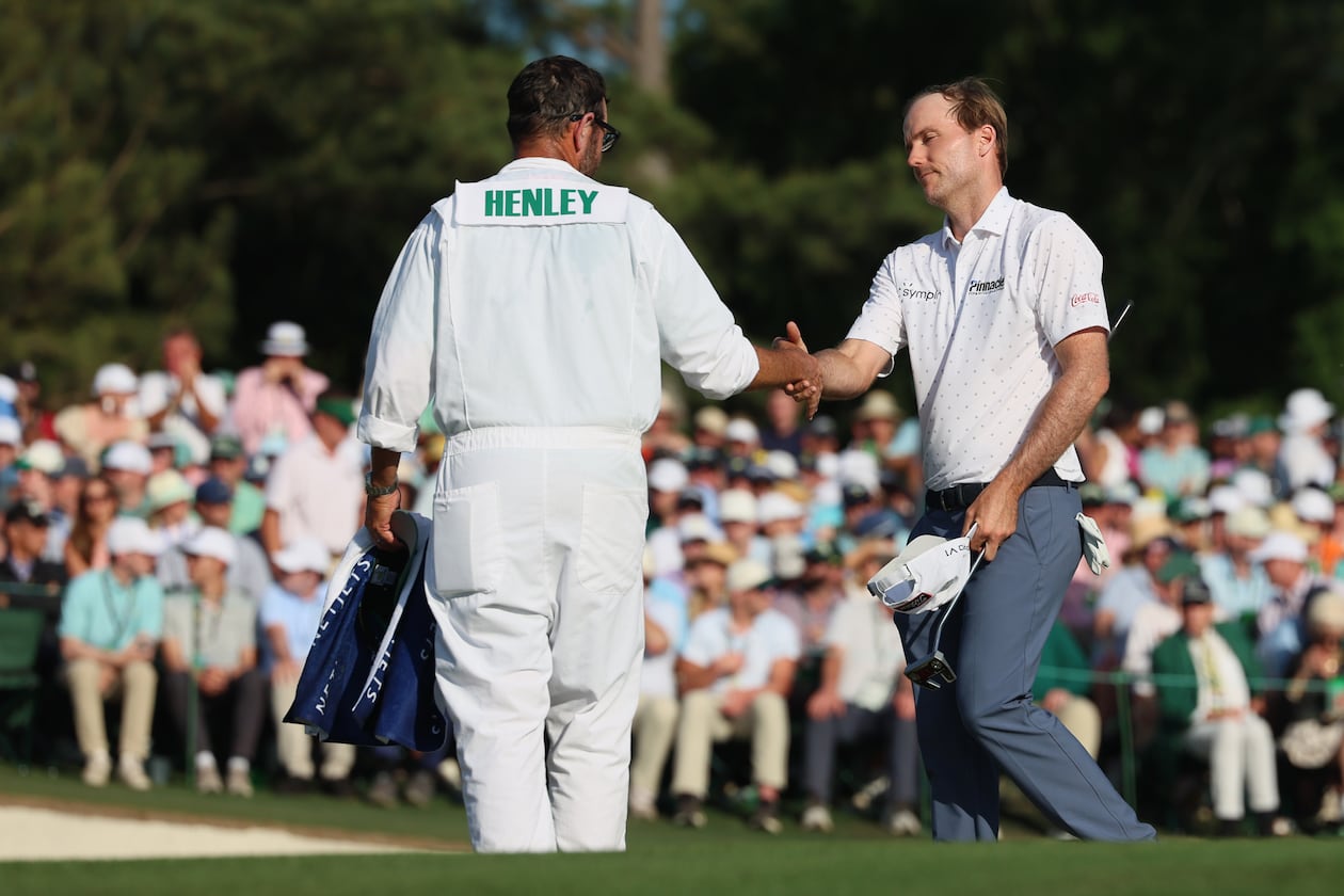 Russell Henley greets his caddie Andrew Sanders at the end of the final round of the Masters at Augusta National Golf Club, Sunday, April 12, 2026, in Augusta, Ga. (Jason Getz/AJC)