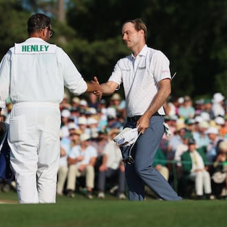 Russell Henley greets his caddie Andrew Sanders at the end of the final round of the Masters at Augusta National Golf Club, Sunday, April 12, 2026, in Augusta, Ga. (Jason Getz/AJC)