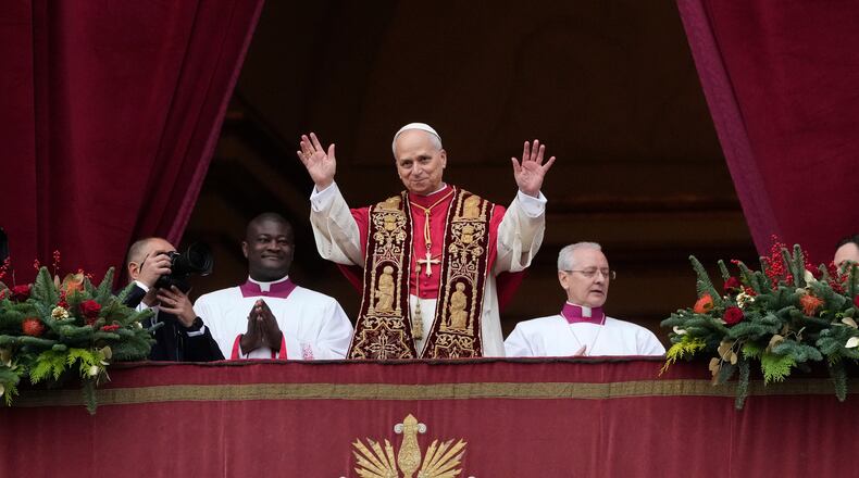 Pope Leo XIV waves after delivering the Urbi et Orbi (Latin for 'to the city and to the world' ) Christmas' day blessing from the main balcony of St. Peter's Basilica at the Vatican, Thursday, Dec. 25, 2025. (AP Photo/Gregorio Borgia)