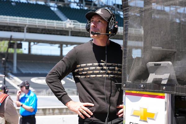 Former Team Penske driver and Indianapolis 500 winner Simon Pagenaud works on the timing stand as a driver coach for Scott McLaughlin during practice for the Indianapolis 500 auto race at Indianapolis Motor Speedway in Indianapolis, Sunday, May 18, 2025. (AP Photo/Michael Conroy)