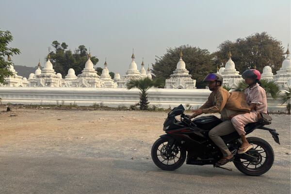 Local residents ride a motorbike past pagodas in the aftermath of Friday's earthquake in Mandalay, Myanmar, Thursday, April 3, 2025. (AP Photo)