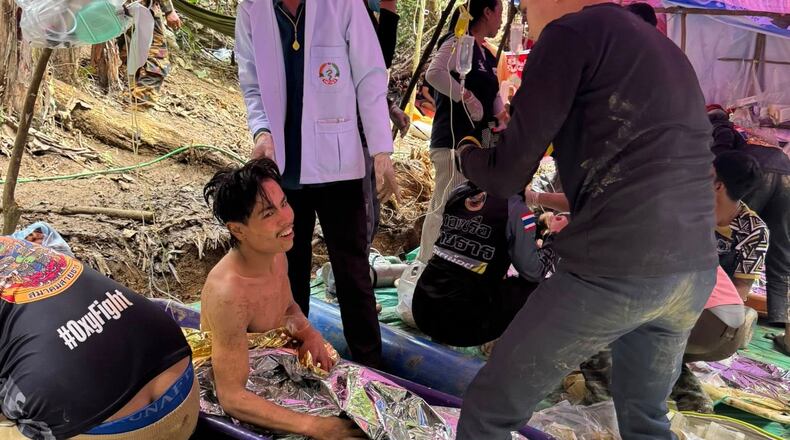 This image provided by the Association Of Volunteers For Lao People, shows rescuers after they safely evacuated the villagers, who had been trapped in a cave in Xaisomboun province, Laos, Saturday, May 30 , 2026. (Association Of Volunteers For Lao People via AP)
