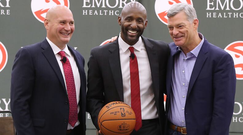 Hawks general manager Travis Schlenk (left) and owner Tony Ressler (right) introduced Lloyd Pierce as the team’s new head coach Monday.