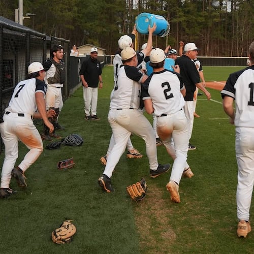 East Paulding players celebrate coach Tony Boyd's 600th victory March 27 in a 15-2 victory over Rome. (Courtesy of East Paulding High School)