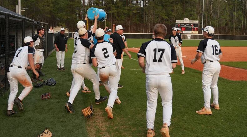 East Paulding players celebrate coach Tony Boyd's 600th victory March 27 in a 15-2 victory over Rome. (Courtesy of East Paulding High School)