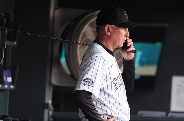 Colorado Rockies manager Bud Black makes a call to the bullpen in the fourth inning of a baseball game against the San Diego Padres, Saturday, May 10, 2025, in Denver. (AP Photo/David Zalubowski)