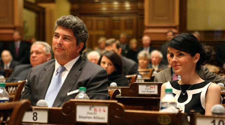 Georgia Supreme Court Justice Michael Boggs, left, listens to a speaker with his wife Heather, right, in the House Chamber at the State Capitol on Jan. 6, 2012. (Photo: Jason Getz, AJC file)