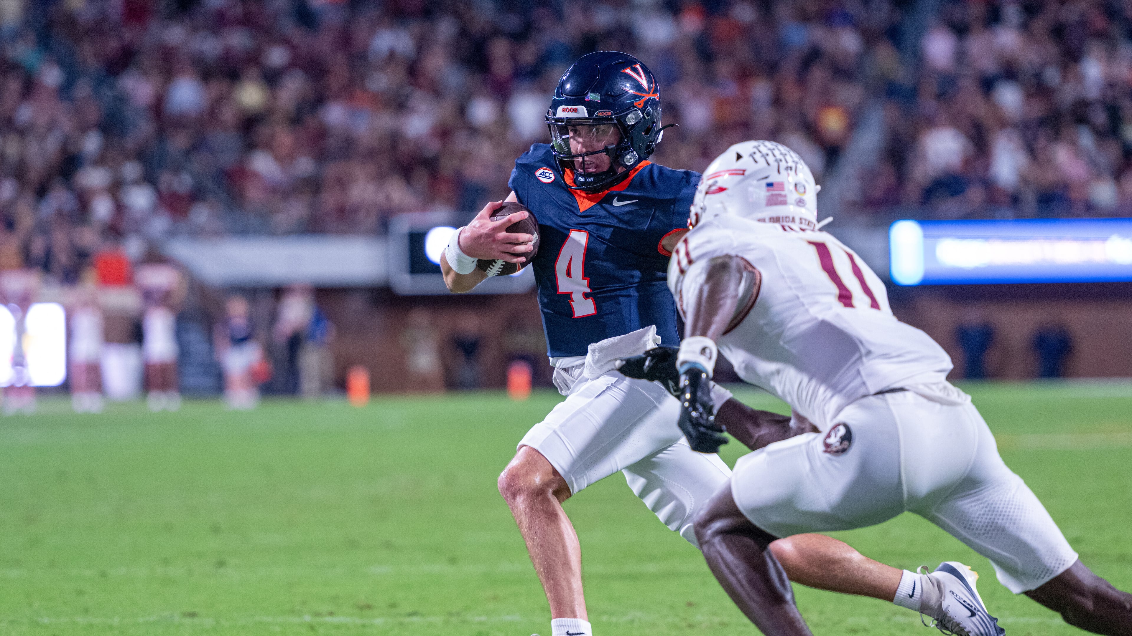 Virginia quarterback Chandler Morris (4) runs the ball in for a touchdown during the first half of an NCAA college football game, Friday, Sept. 26 2025, in Charlottesville, Va. (AP Photo/Robert Simmons)