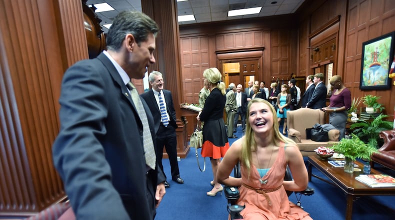 August 23, 2016 Atlanta - Aimee Copeland shares a smile with Chris Brand (left), president/CEO of Friends of Disabled Adults & Children, before they meet and take a picture with Gov. Nathan Deal at The Georgia State Capitol Tuesday morning, August 23, 2016. Personal Journey: Aimee Copeland was attending the University of West Georgia when, on May 1, 2012, she fell from a zipline running over the Little Tallapoosa River. Her left leg was gashed and left susceptible to necrotizing fasciitis, which threatened her life and led to amputations of both hands, her left leg and her right foot. Since then, she's completed Master's degrees in humanistic psychology and social work. She's also become an advocate for people with disabilities. HYOSUB SHIN / HSHIN@AJC.COM
