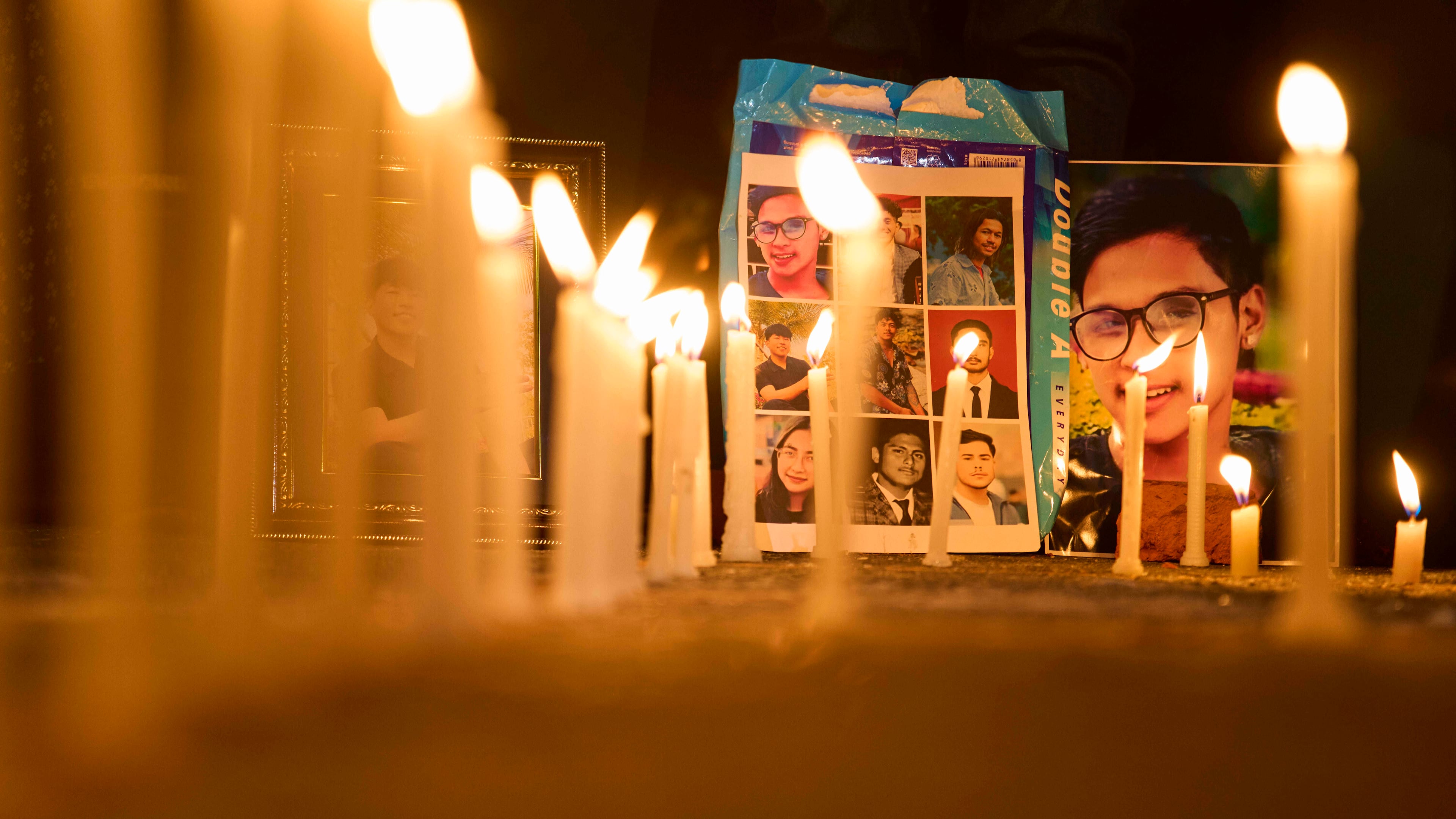 Photos of people who were killed during the Sept. 8 protest are placed outside the morgue of Teaching Hospital in Kathmandu, Nepal, during a candlelight vigil, Thursday, Sept. 11, 2025. (AP Photo/Niranjan Shrestha)